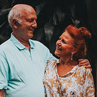 middle-aged man and woman couple smiling at each other